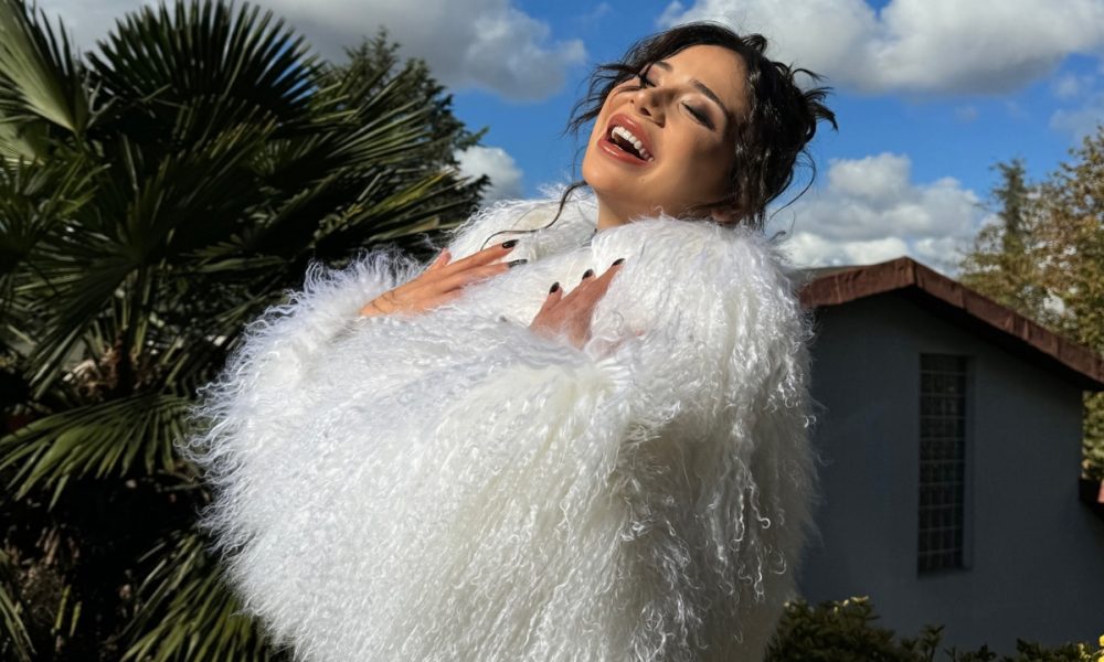 Merve Taskin in white fur dress